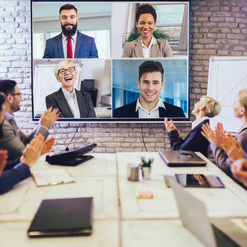 photo of office workers sitting around a table having a videoconference call. They are 401K advisors doing retirement planning near me in Gilbert and Tempe Arizona